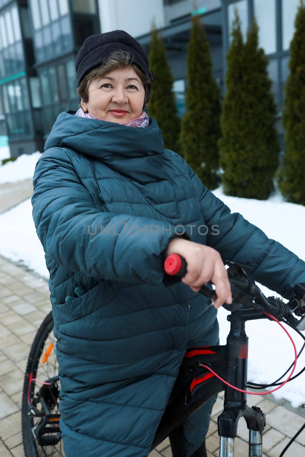 An elderly woman went for a bike ride in the cold.