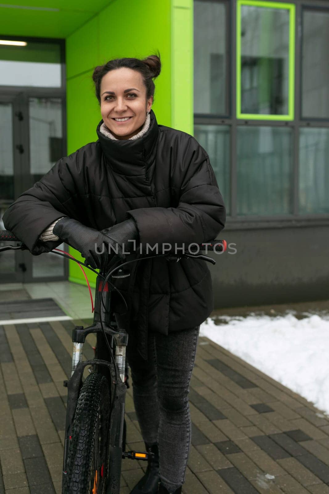 A pretty woman dressed in a black jacket went out for a walk and rented a bicycle.