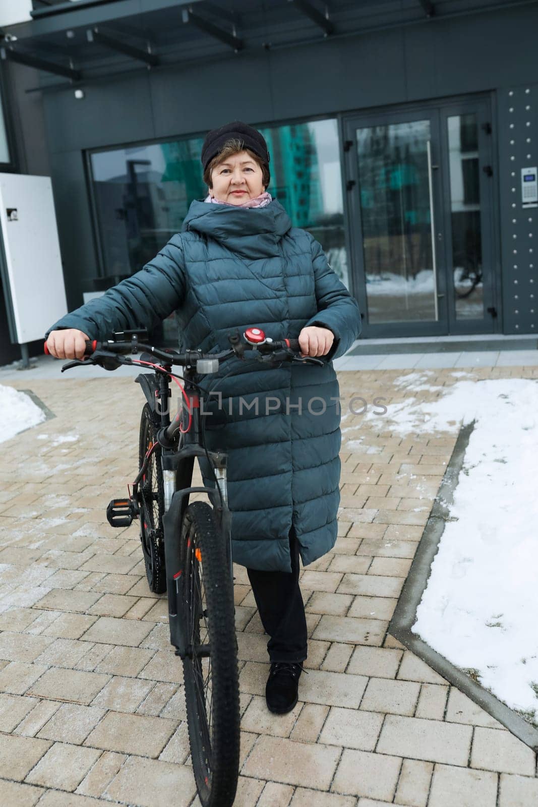 An elderly woman went for a bike ride in the cold.