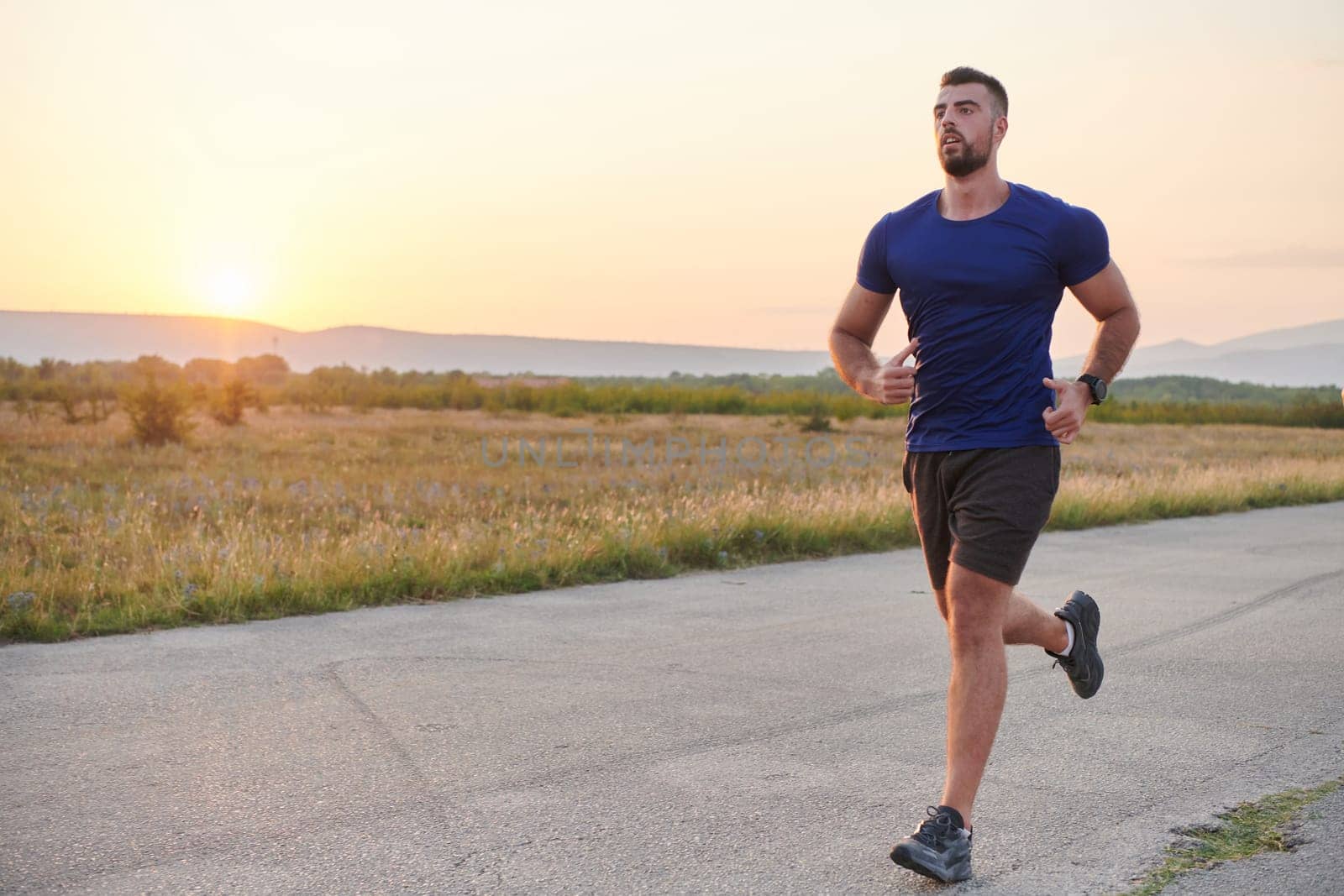 A highly motivated marathon runner displays unwavering determination as he trains relentlessly for his upcoming race, fueled by his burning desire to achieve his goals.