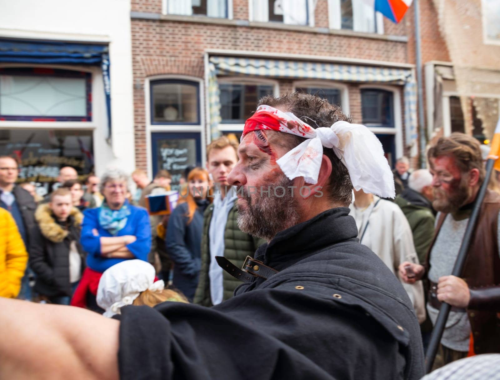 Brielle,Holland,1-04-2024:man plays wounded man in traditional traditional costumes celebration of the the first town to be liberated from the Spanish in Den Briel in the Netherlands in 1572