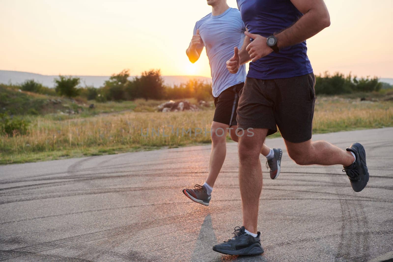 In anticipation of an upcoming marathon competition, two athletic friends train side by side, embodying the spirit of teamwork, dedication, and mutual support in their shared fitness journey.