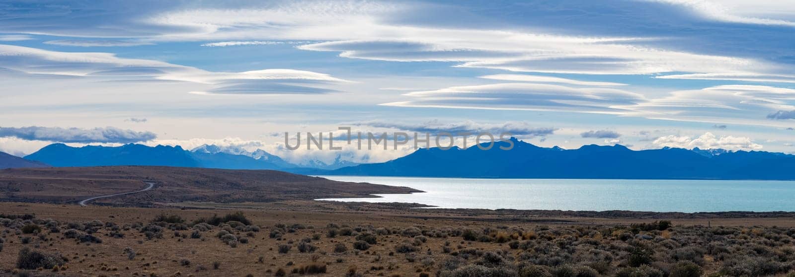 Expansive Patagonian Landscape with Lenticular Clouds and Lake by FerradalFCG