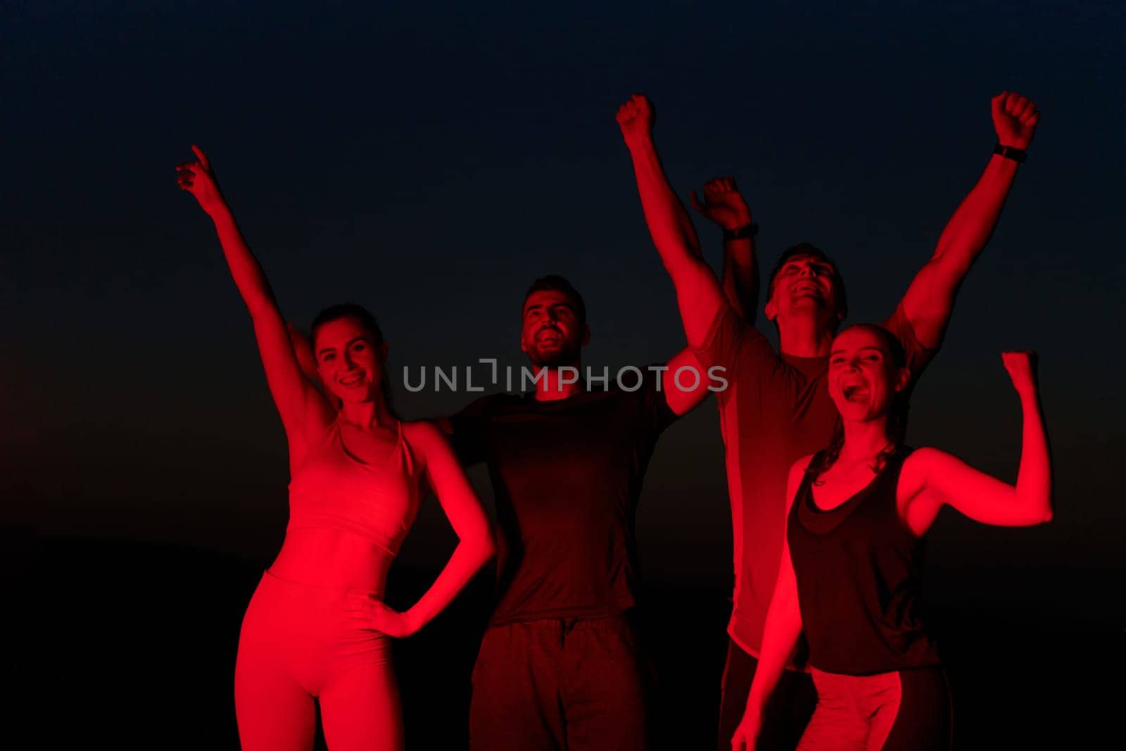 Late-Night Triumph: Group of Friends Celebrate Marathon Success. by dotshock