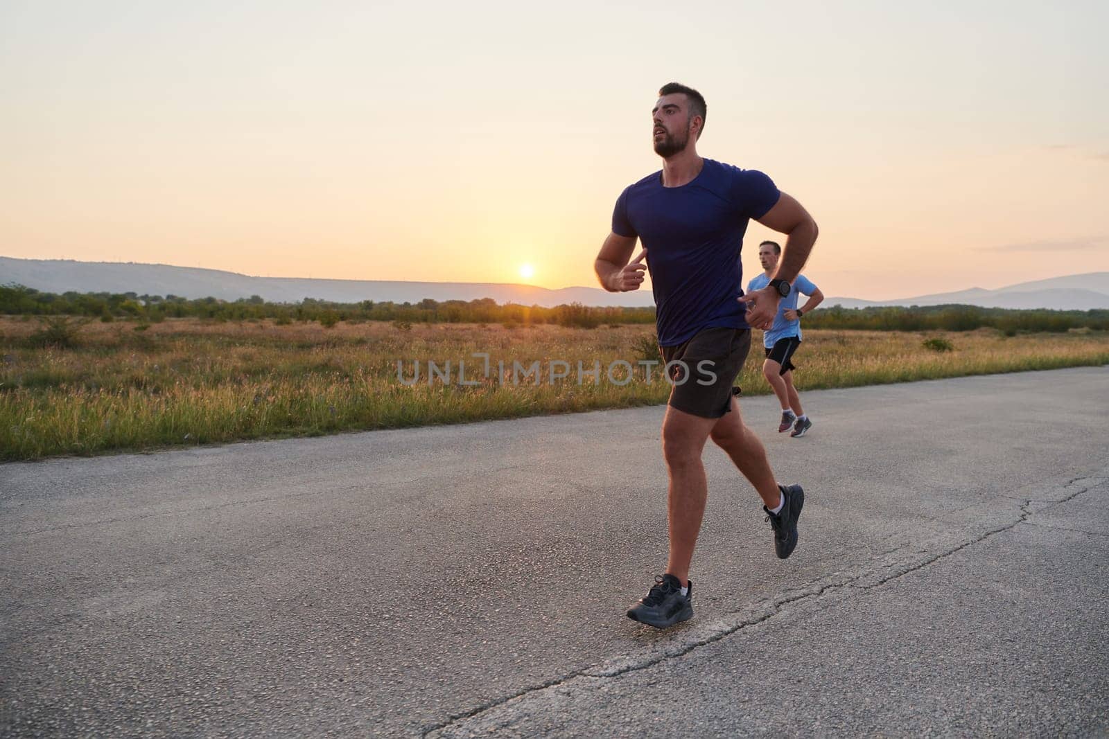 In anticipation of an upcoming marathon competition, two athletic friends train side by side, embodying the spirit of teamwork, dedication, and mutual support in their shared fitness journey.