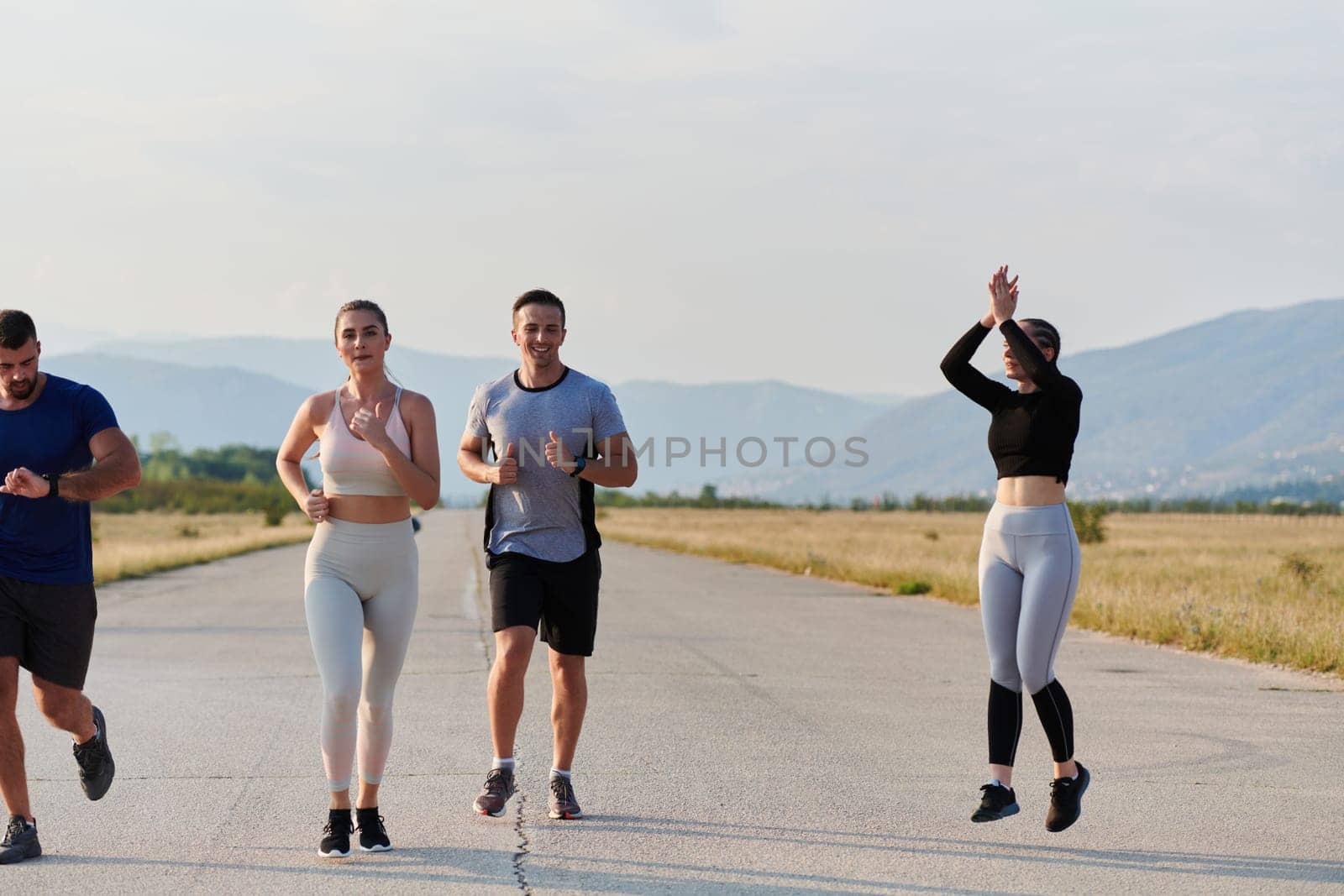 A group of friends maintains a healthy lifestyle by running outdoors on a sunny day, bonding over fitness and enjoying the energizing effects of exercise and nature.