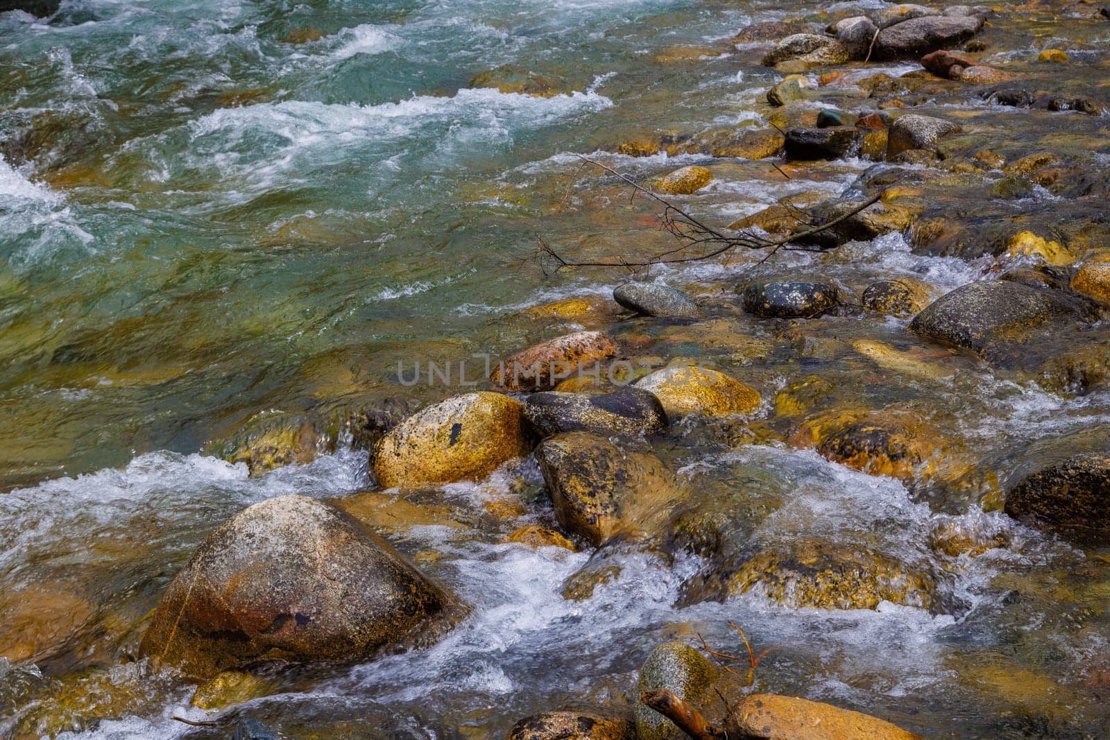 a river flowing over rocks in the mountains at summer day, full-frame closeup view by z1b