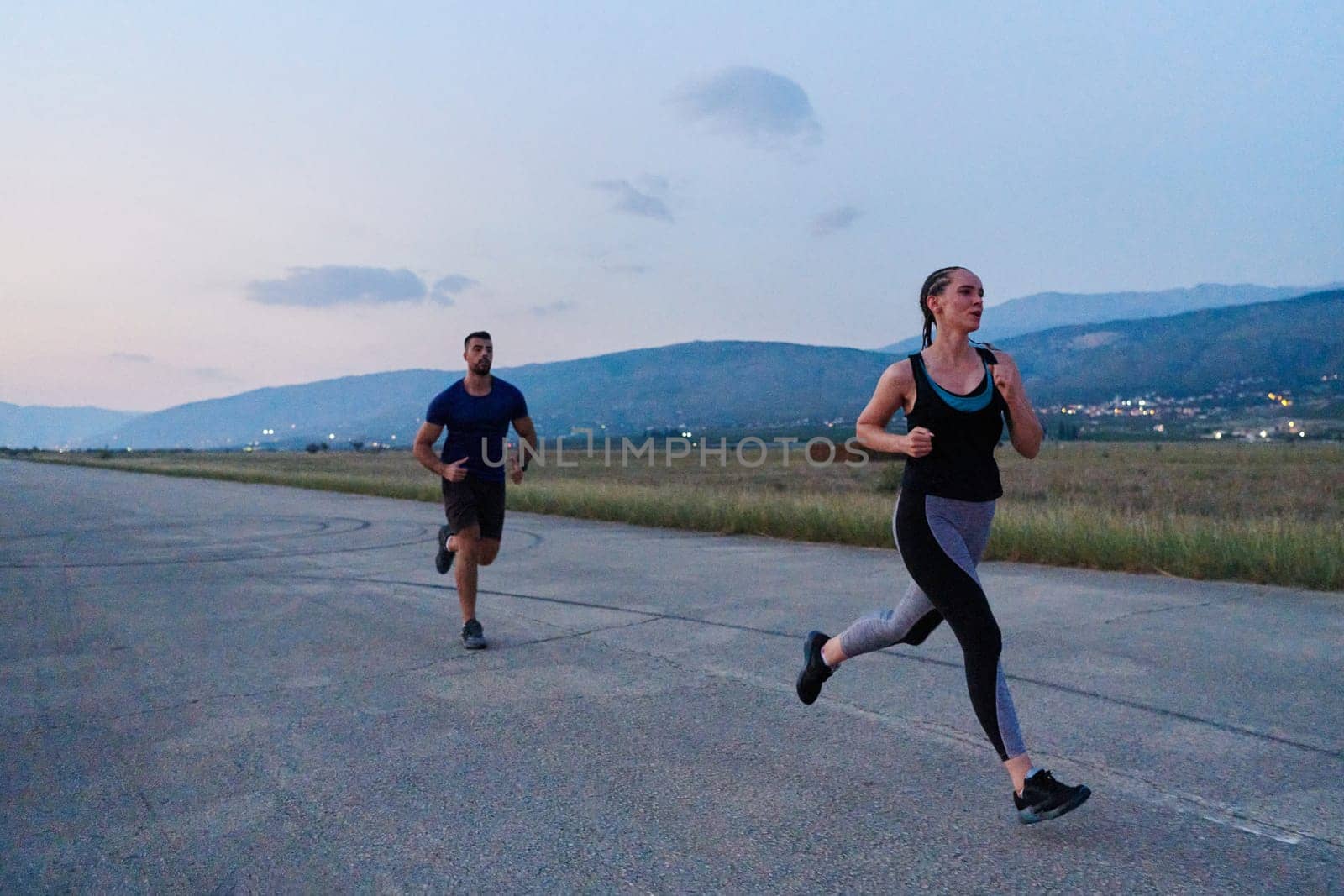 A group of friends maintains a healthy lifestyle by running outdoors on a sunny day, bonding over fitness and enjoying the energizing effects of exercise and nature by dotshock