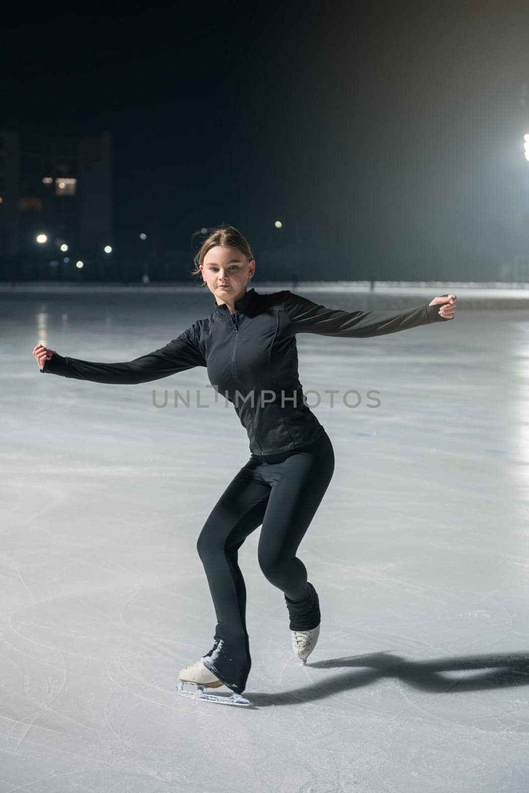 Beautiful young woman ice skating by rusak