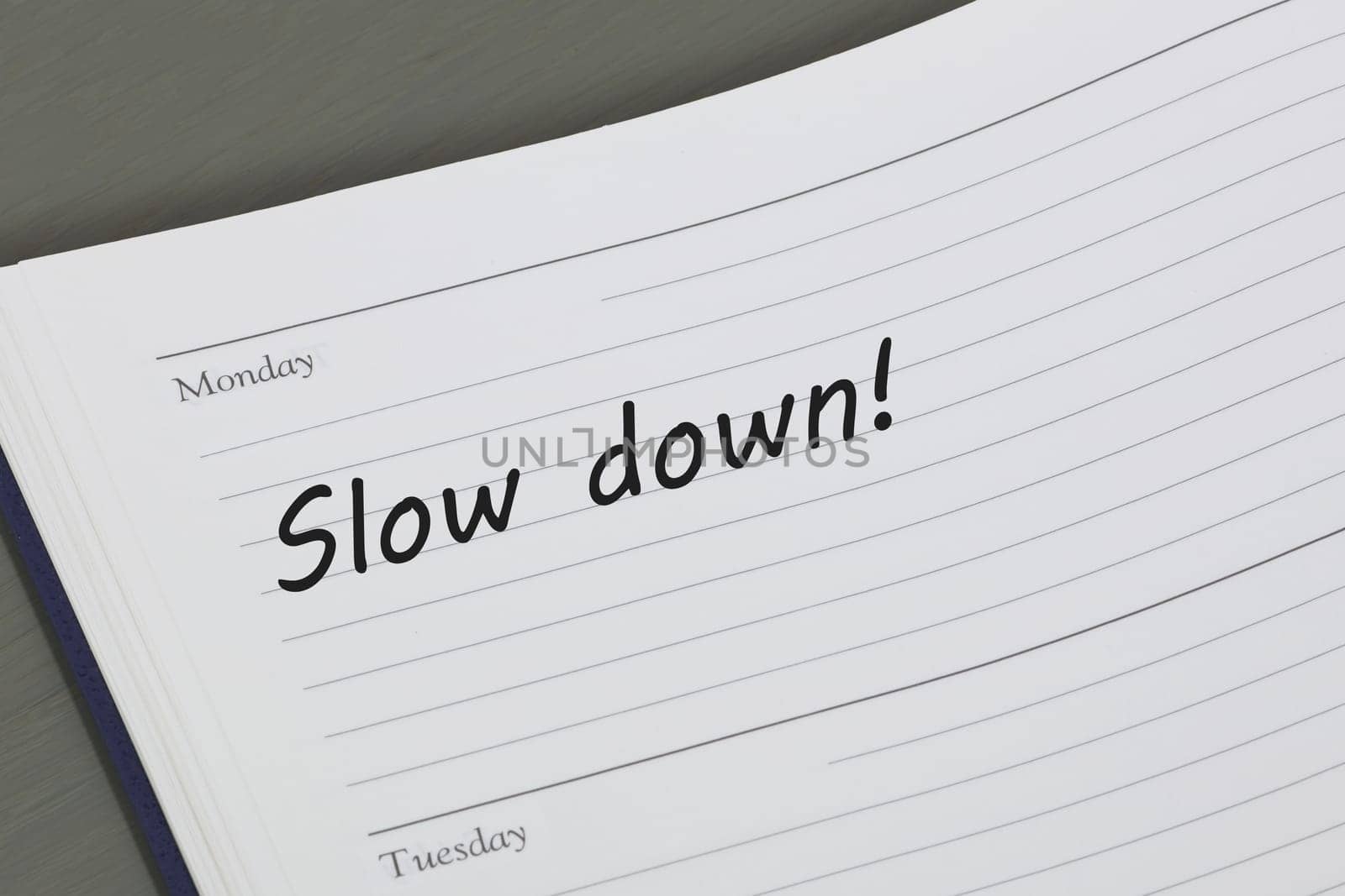 Slow down reminder message in an open diary by VivacityImages