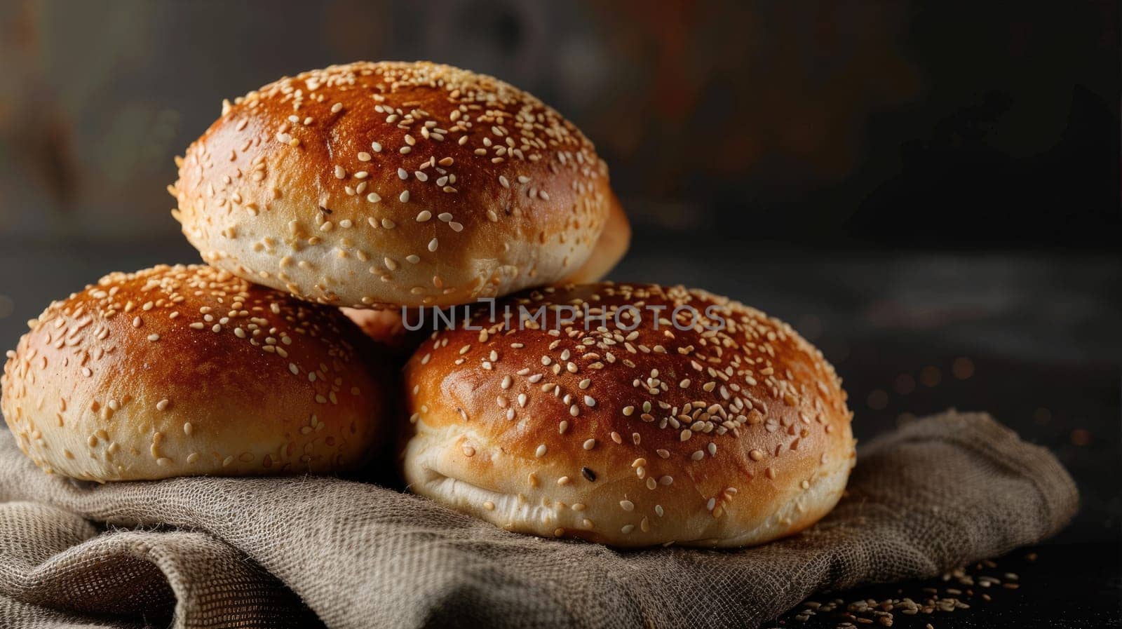 Lush buns with sesame seeds on a dark plate on a dark background by natali_brill