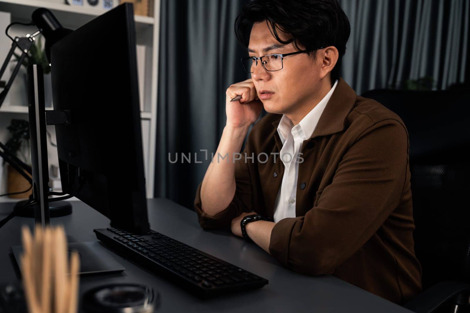 Businessman focusing computer business plan report over late night. Infobahn. by biancoblue