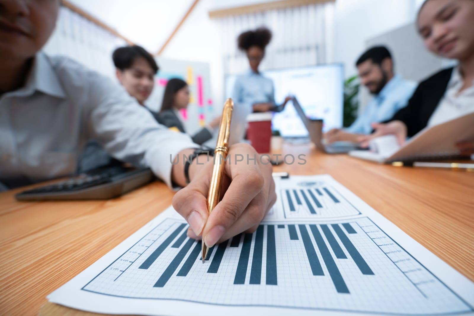 Focus financial dashboard paper showing graphs and chart with blurred background of diverse business people analyzing business data by BI Fintech technology for business marketing indication. Concord