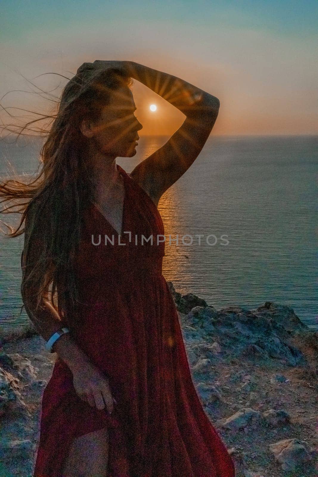 Woman sunset sea red dress, portrait happy beautiful sensual woman in a red long dress posing above the sea on sunset. by Matiunina