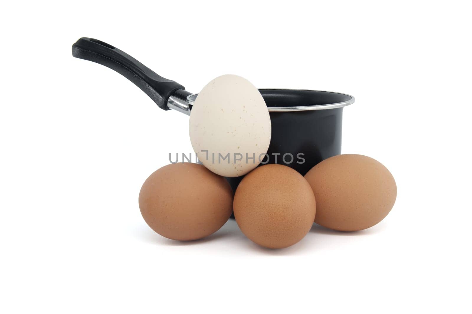 Black cooking pot surrounding collection of eggs with varying colors, isolated on white background