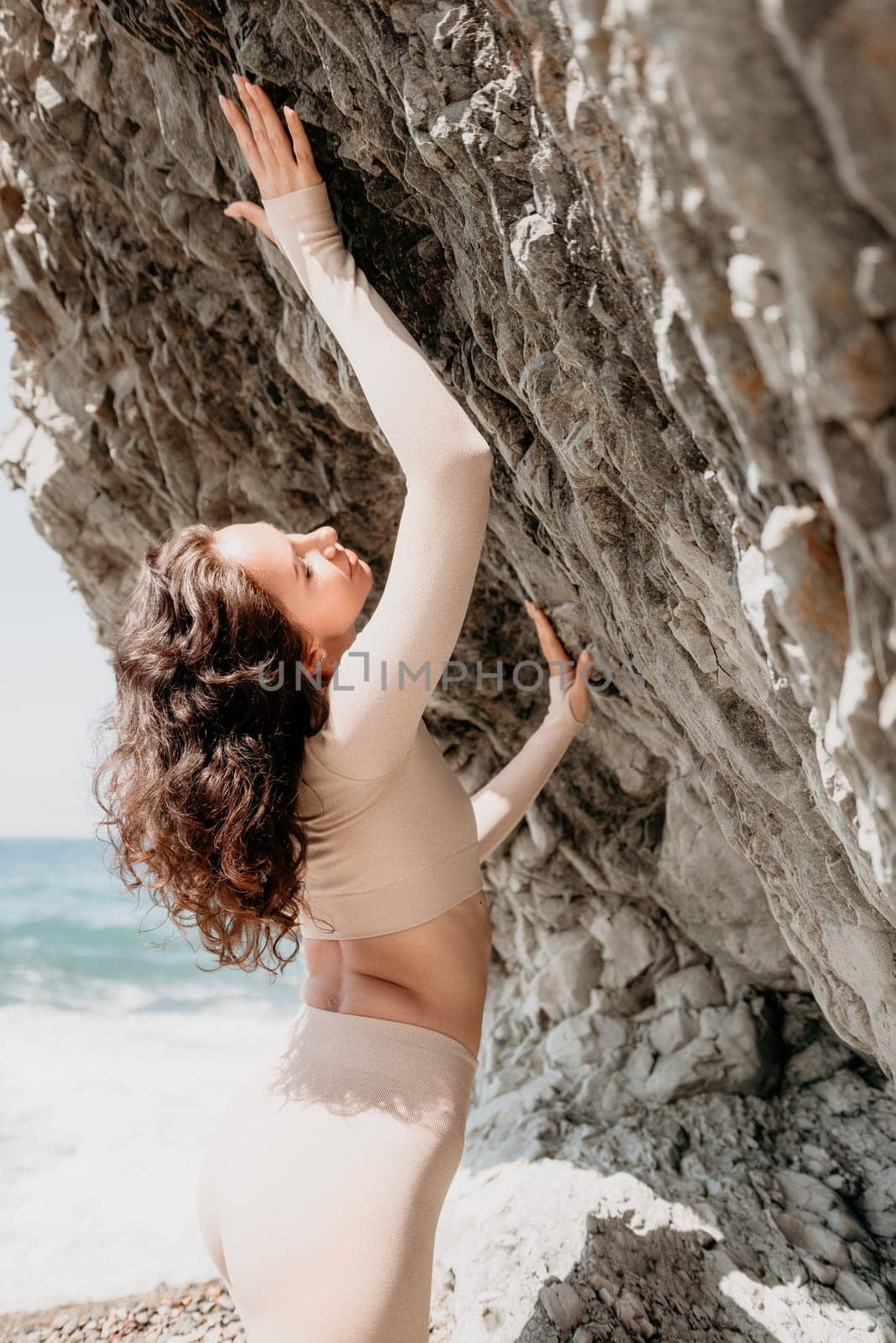 Happy young attractive brunette woman in red swimsuit, on the beach and sea background. Holiday vacation and travel concept.