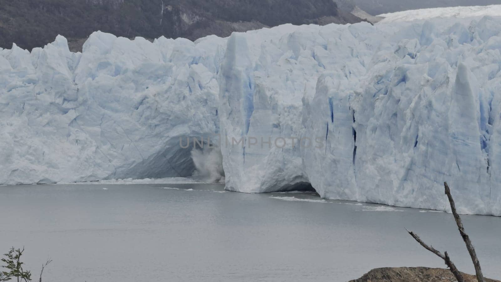 Ice chunks fall from Perito Moreno Glacier's cave into the water below.