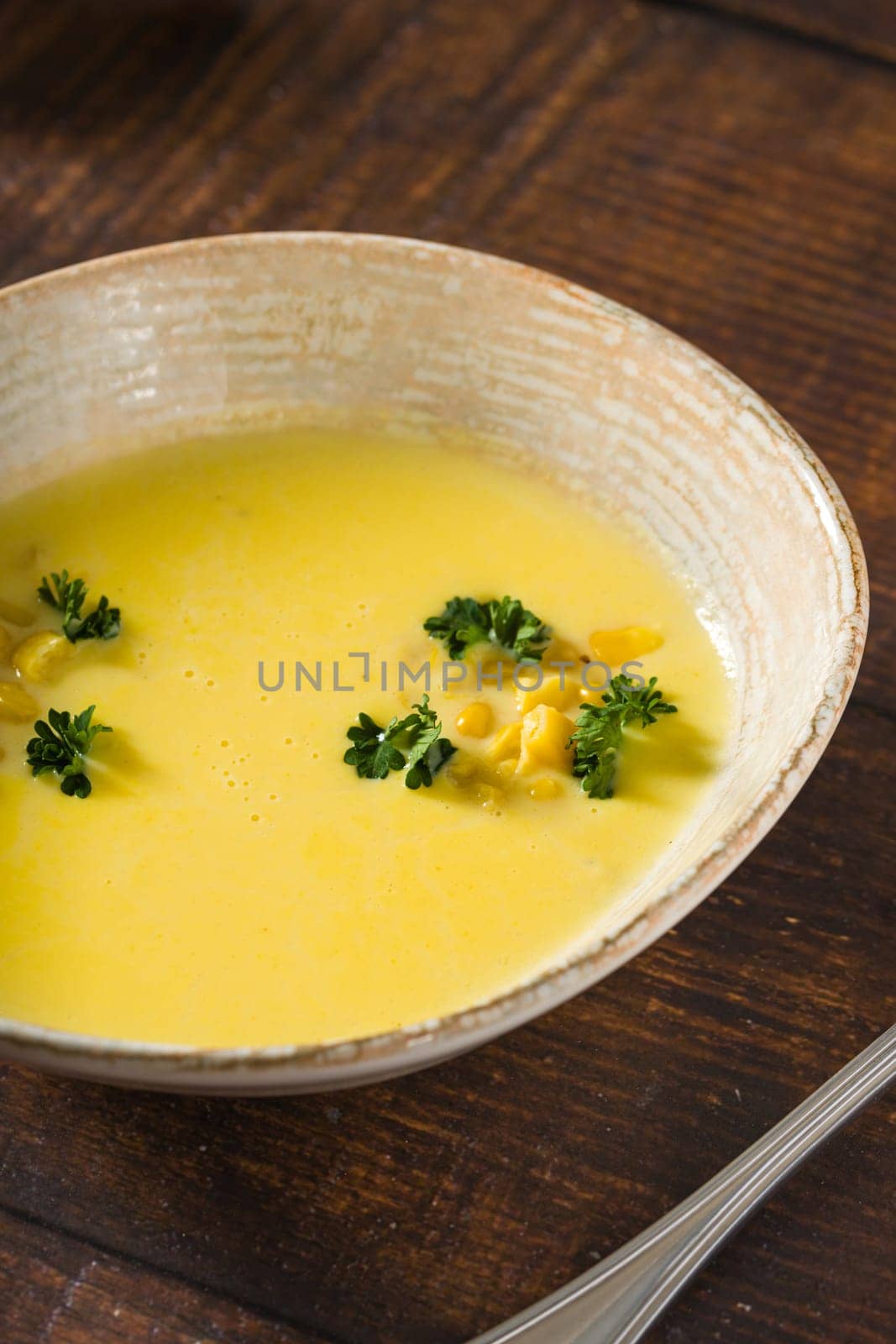 Top view of Italian corn soup on wooden table by Sonat