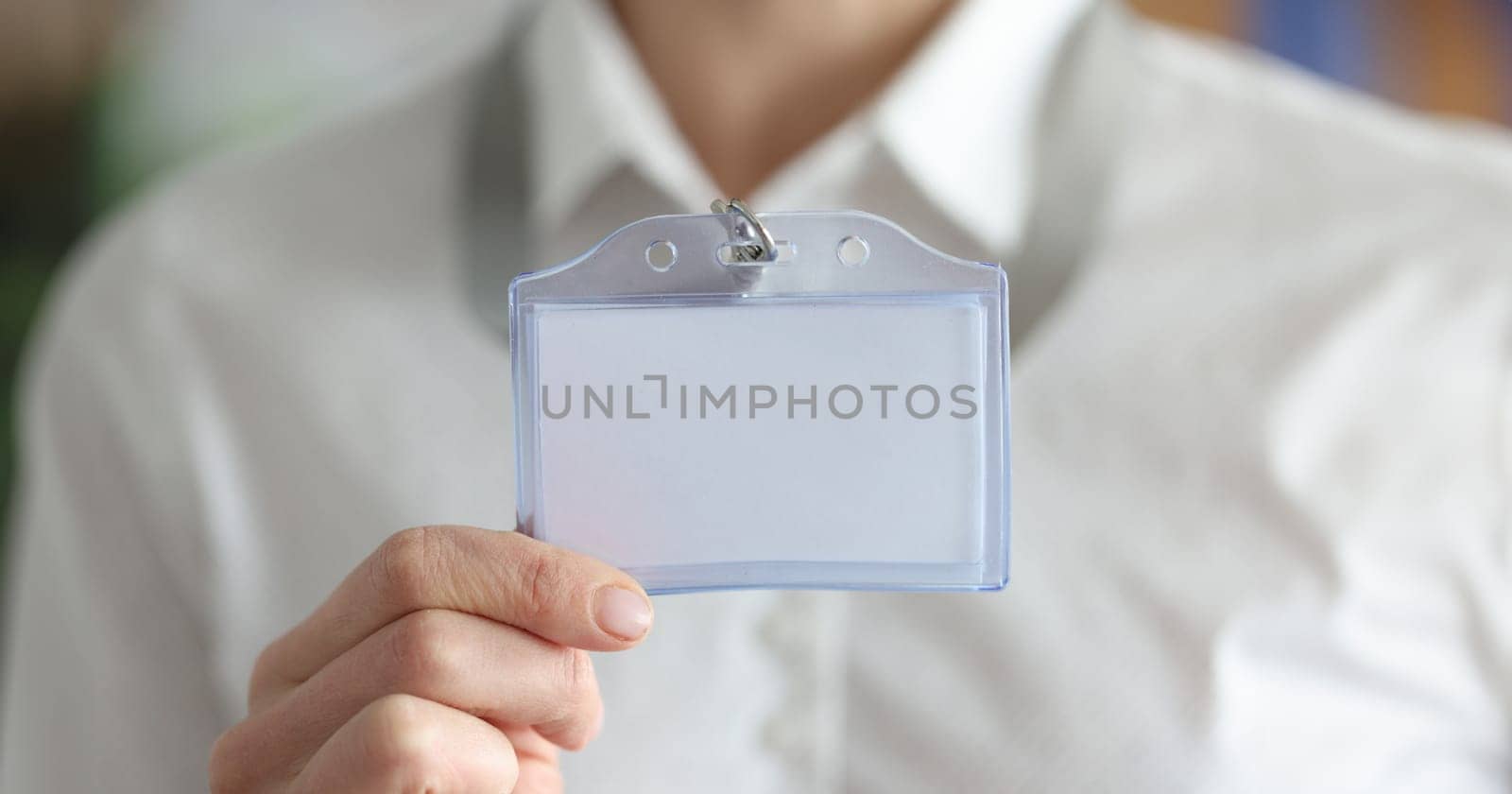 Woman holding blank badge in hand closeup by kuprevich