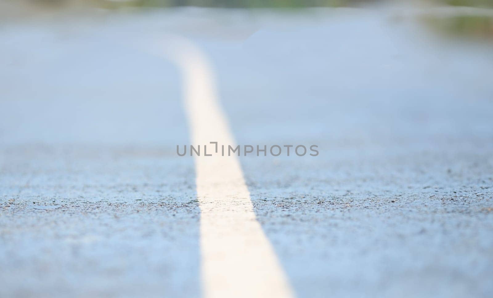 Closeup of white dividing strip on road. Cycling on bike path concept