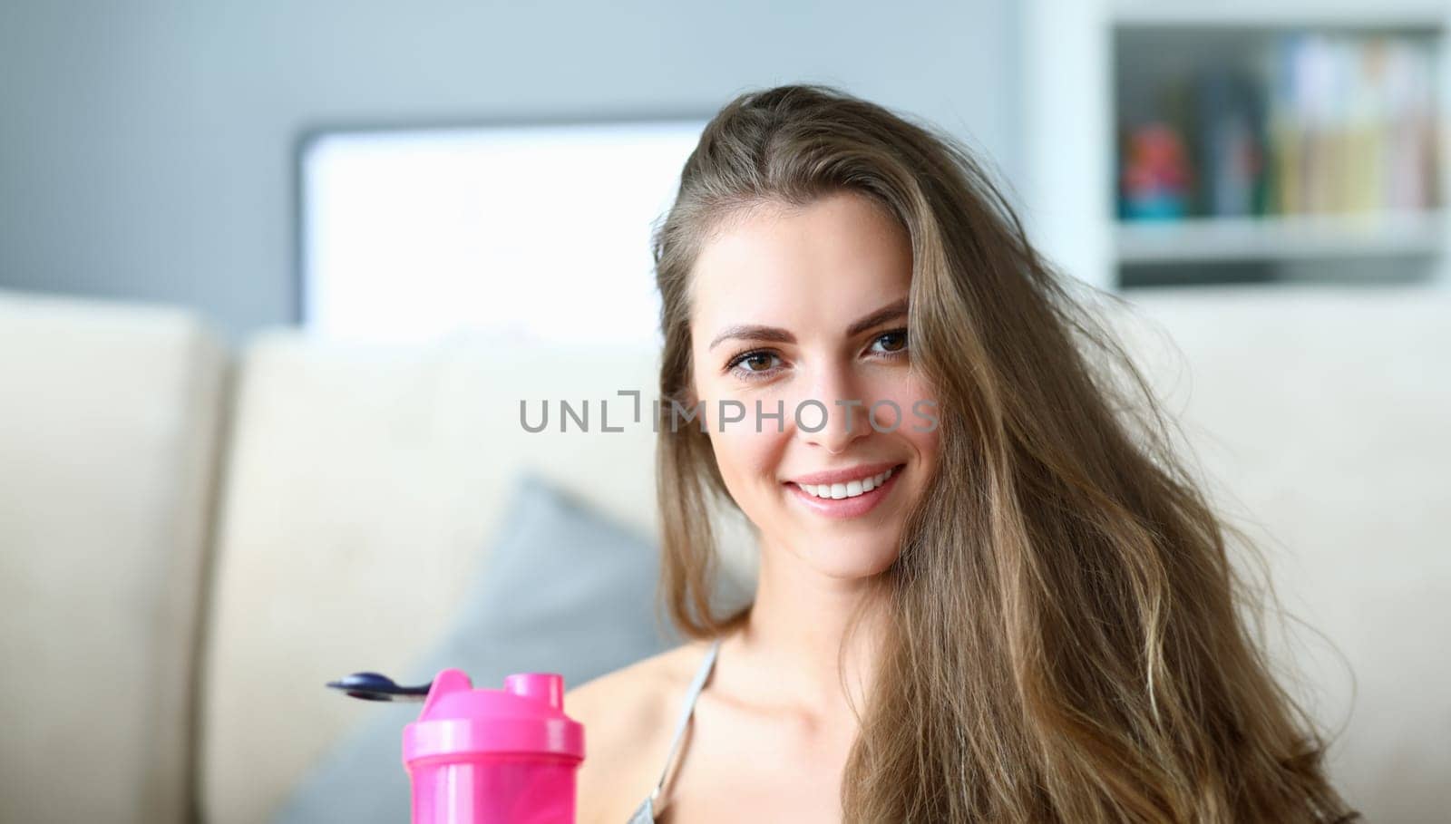 Girl drinks water from bottle prevent dehydration. Woman burns fat and training forms figure. Girl is preparing for exercises, weight loss marathon. Active lifestyle to maintain good health.
