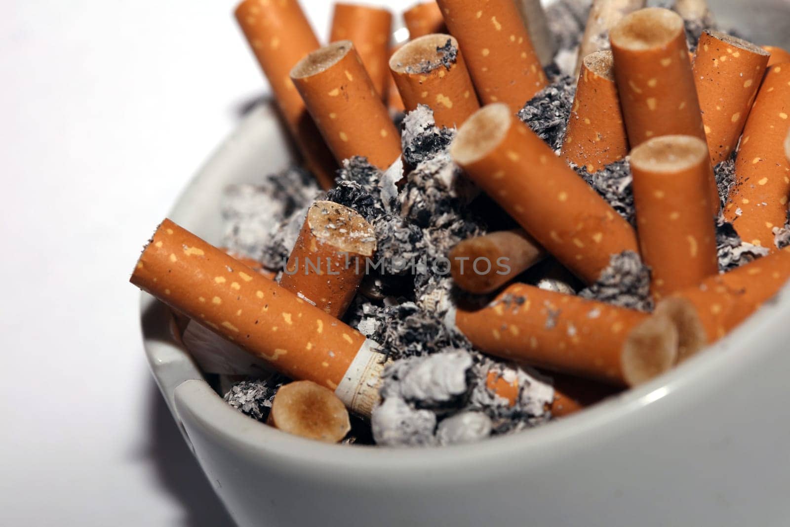 Full ashtray of cigarettes close up macro view smoking habits hi-res stock photography and images high quality big size instant download by BakalaeroZz