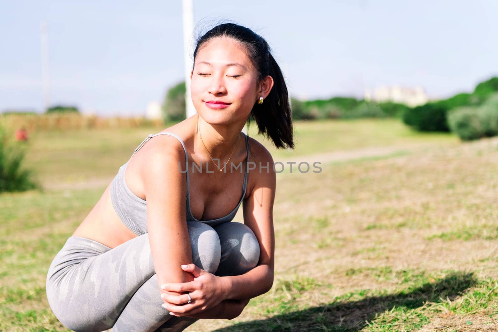 young woman in sportswear smiling happy at park by raulmelldo
