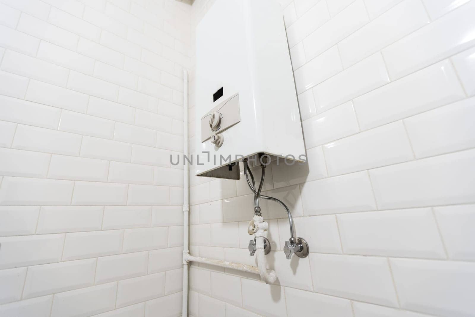 Broken Modern Water Gas Heater Next to Shower Cabin Inside Elegant Clean Bathroom Interior. High quality photo