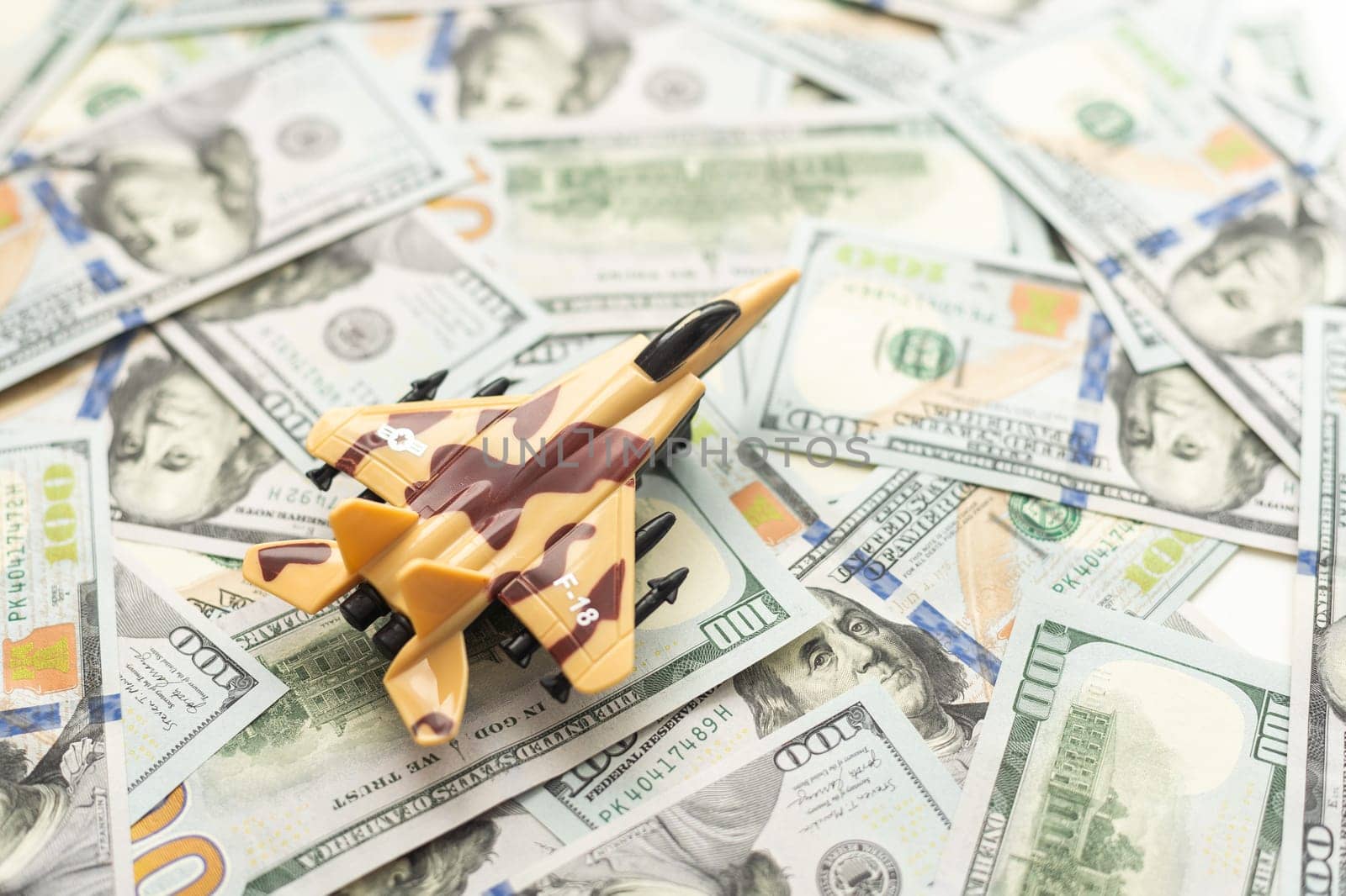 Military toy airplane jet aircraft - on money background. High quality photo