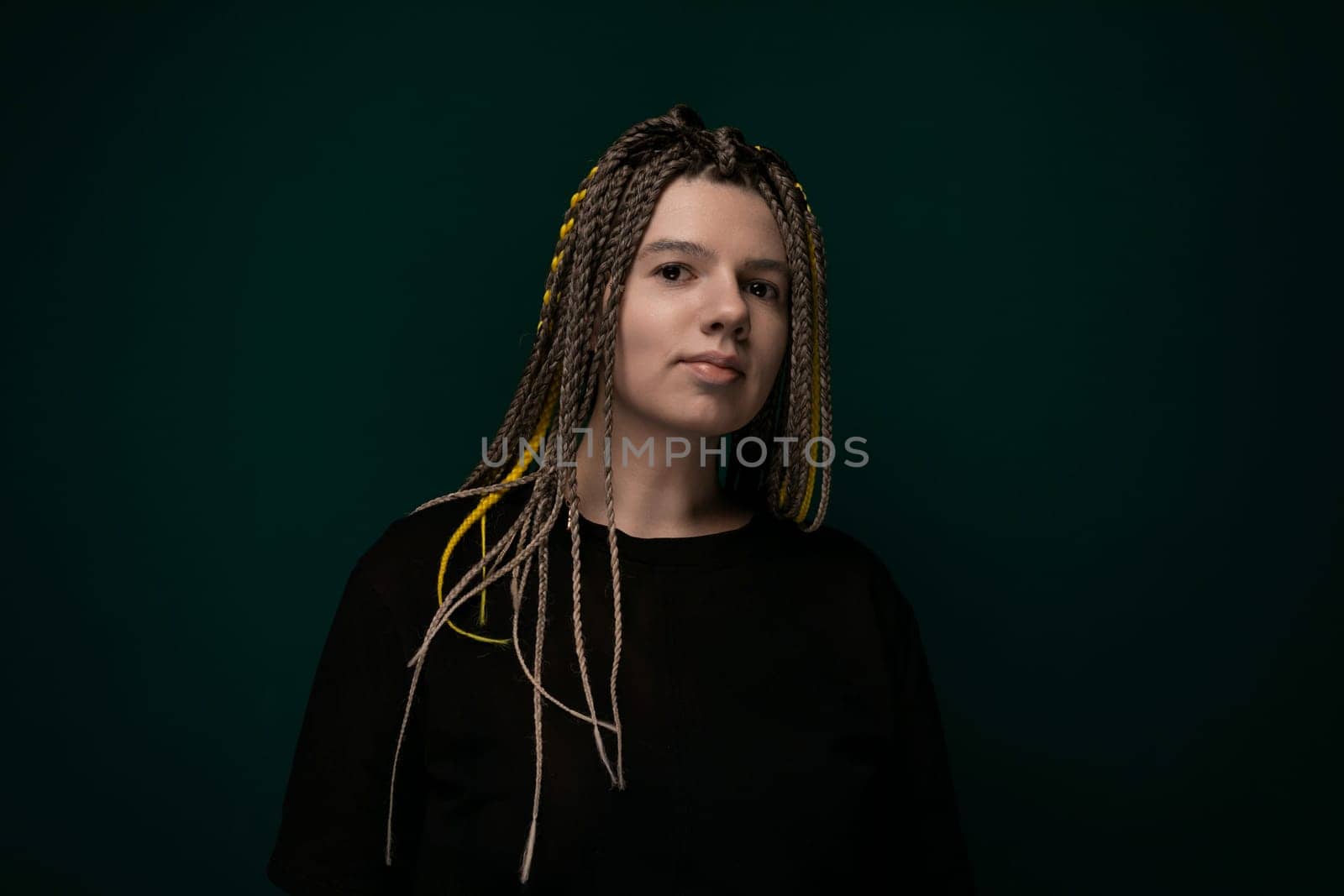 Woman With Dreadlocks Standing in Front of Green Background by TRMK