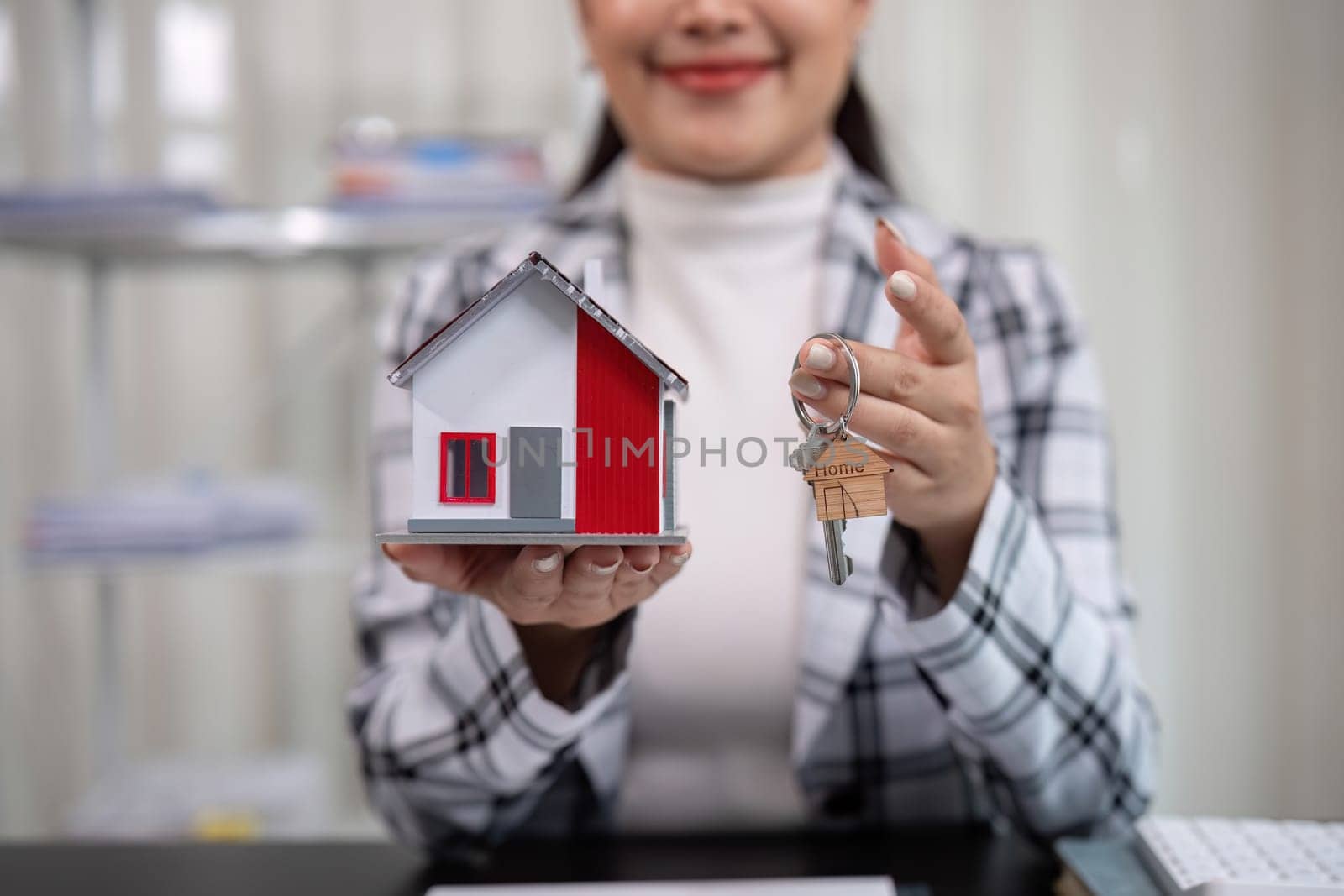 real estate broker Agents deliver sample homes and house keys to customers. The concept of buying and selling houses and real estate. by wichayada
