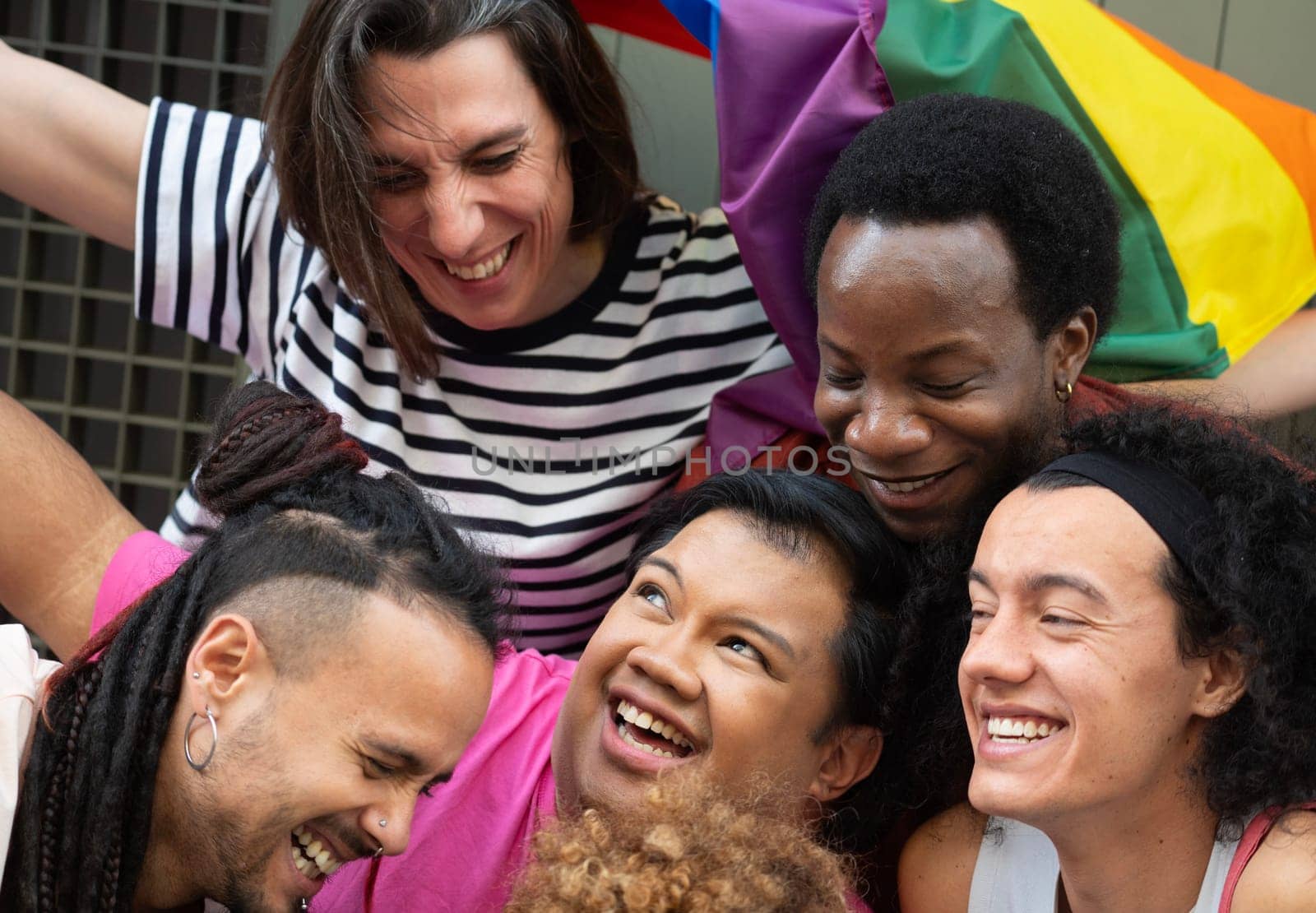 Close up of multicultural people smiling and hugging each other. Embracing diversity by papatonic