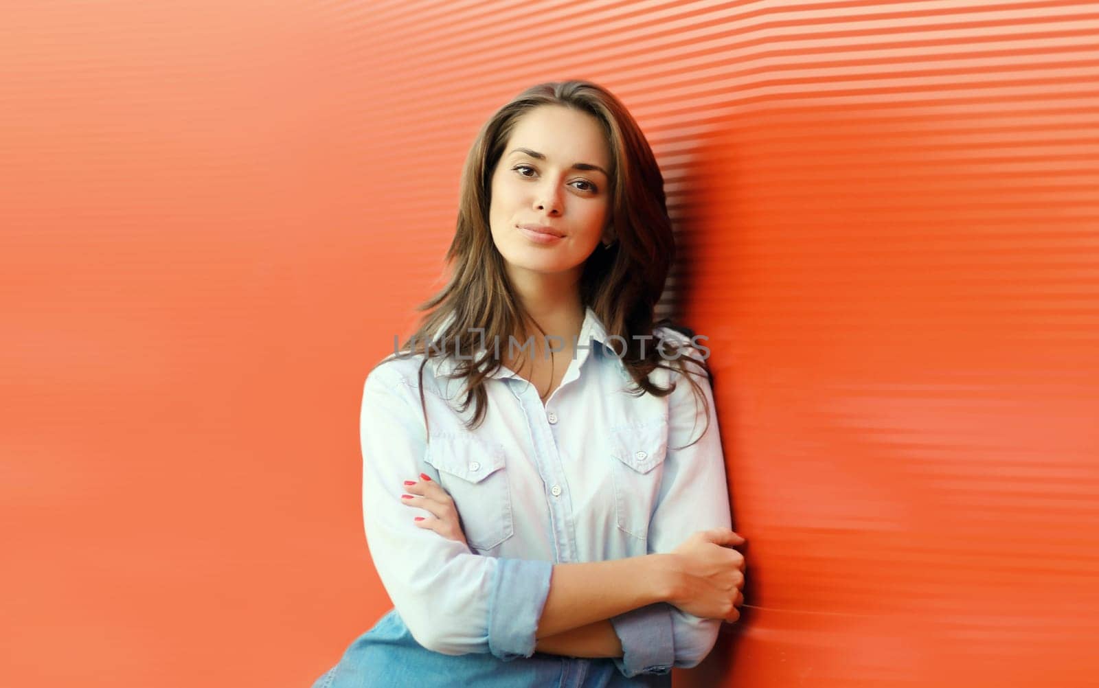 Portrait of beautiful happy smiling brunette young woman posing in the city