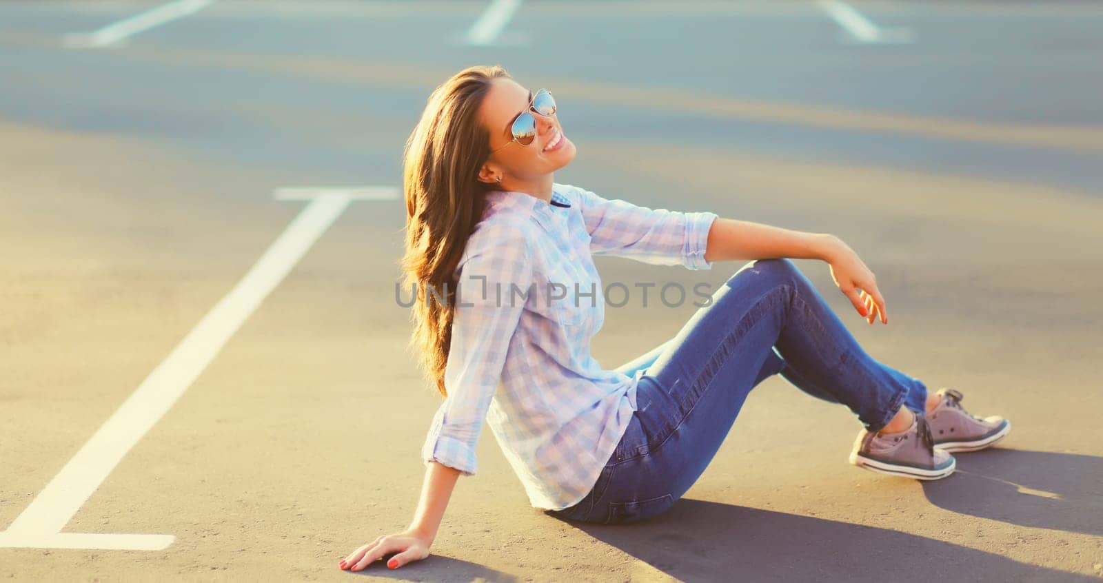 Portrait of beautiful happy smiling brunette young woman posing in the city