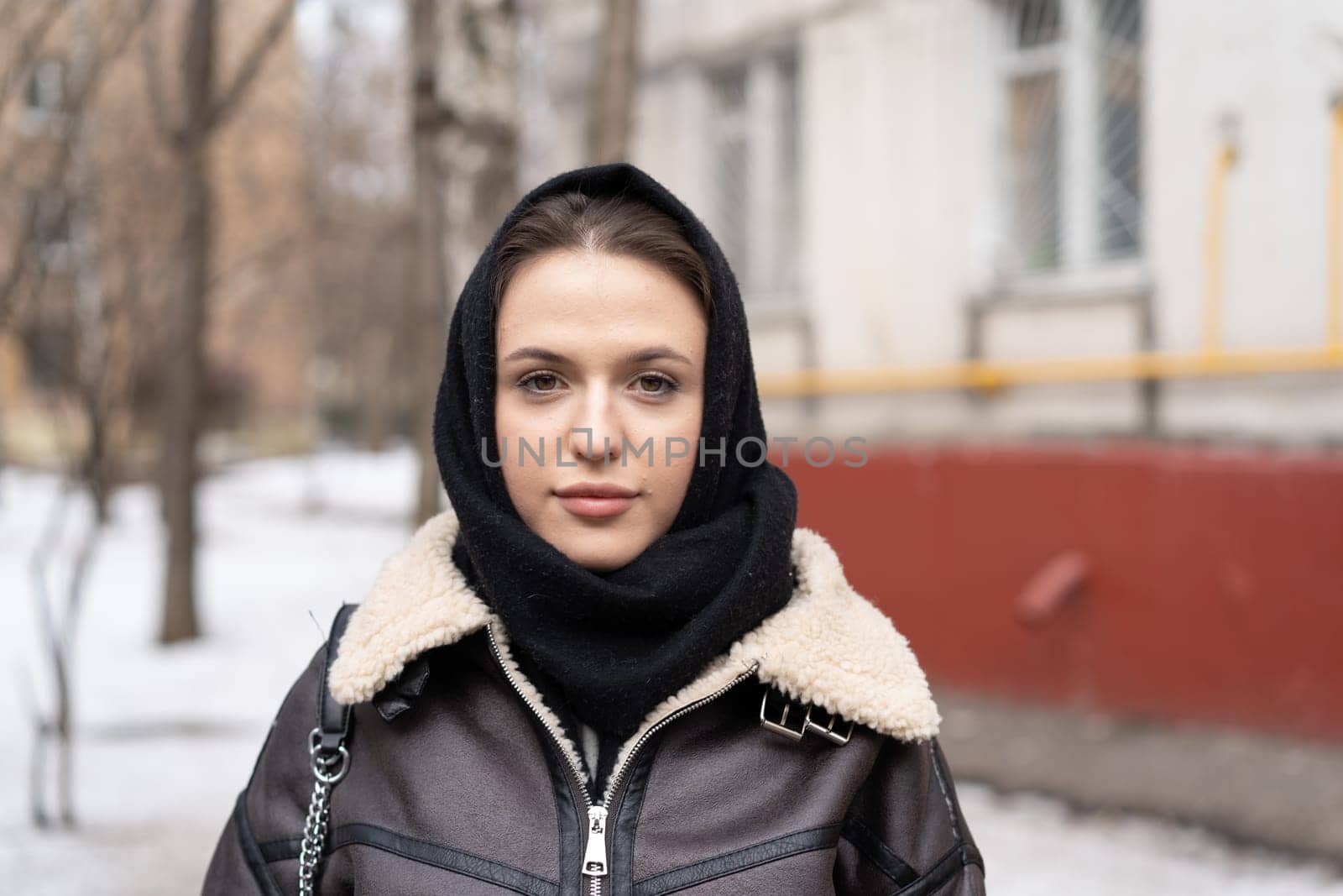 portrait of a young beautiful woman outside wearing a headscarf