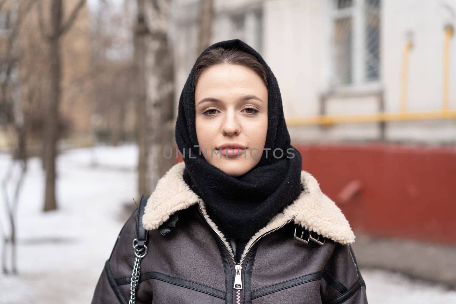 portrait of a young beautiful woman outside wearing a headscarf