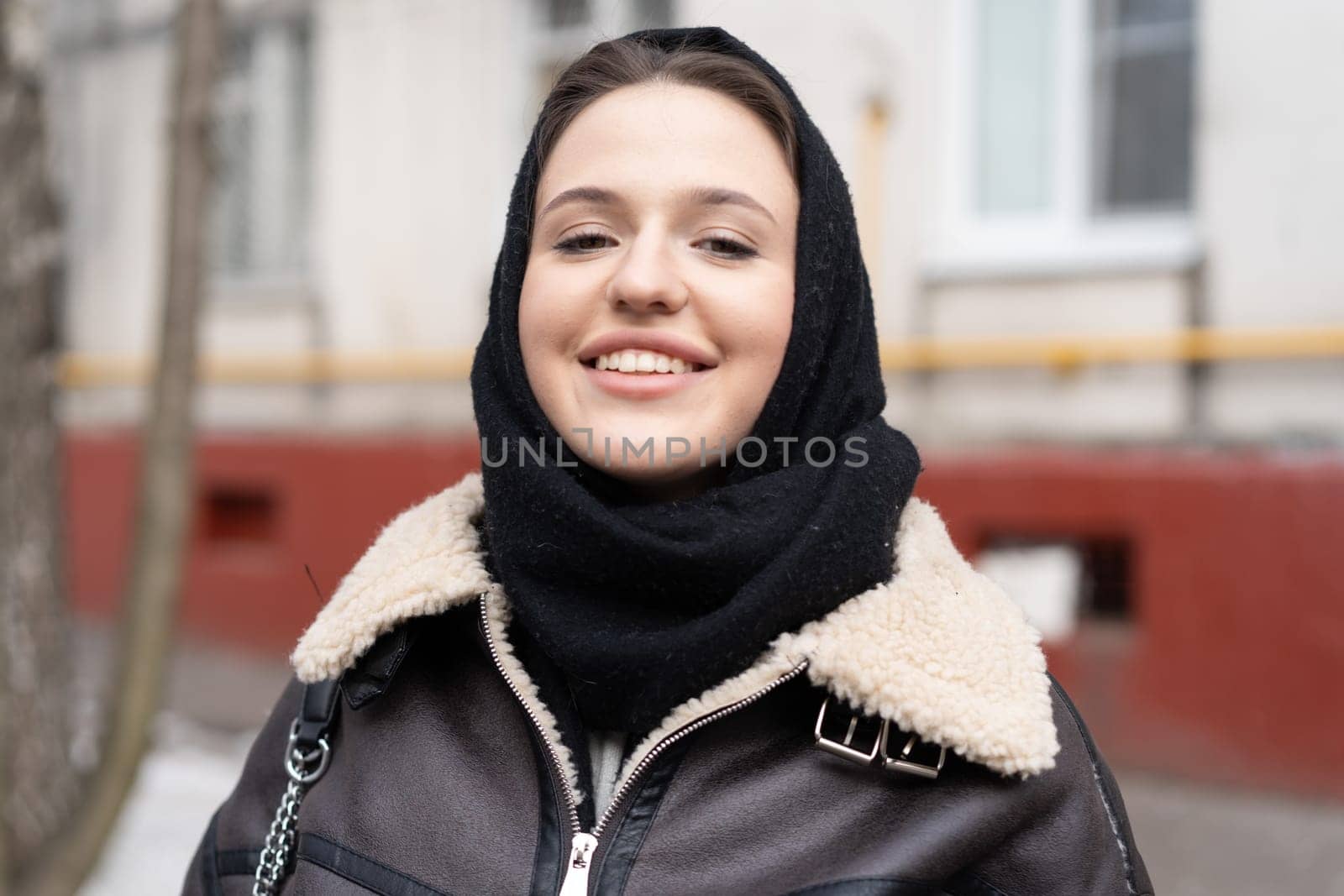 portrait of a young beautiful woman outside wearing a headscarf