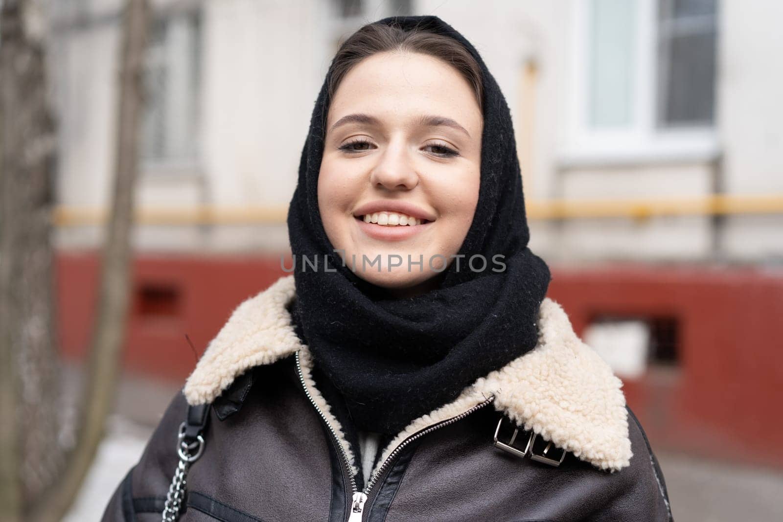 portrait of a young beautiful woman outside wearing a headscarf