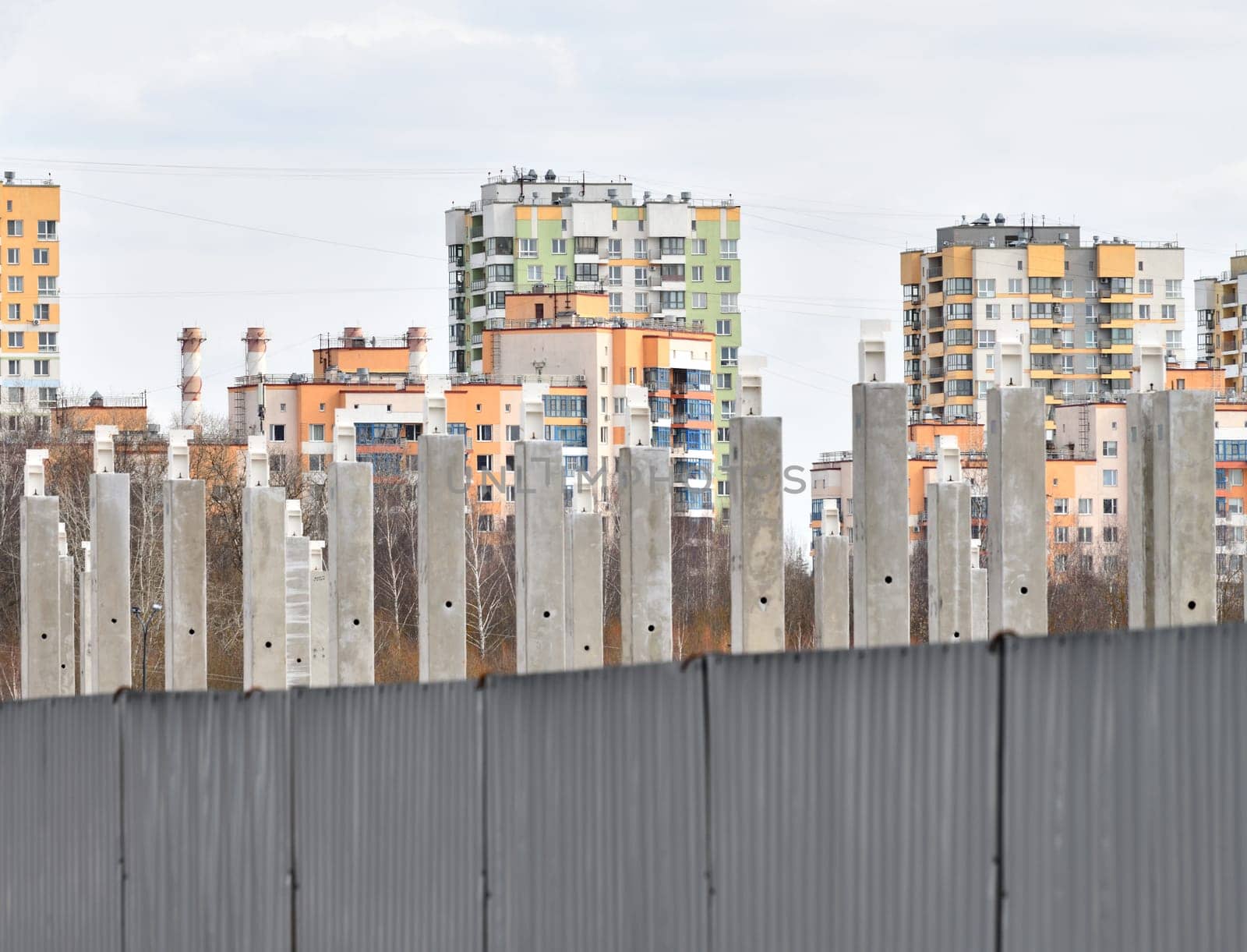Concrete piles against the background of new buildings by olgavolodina