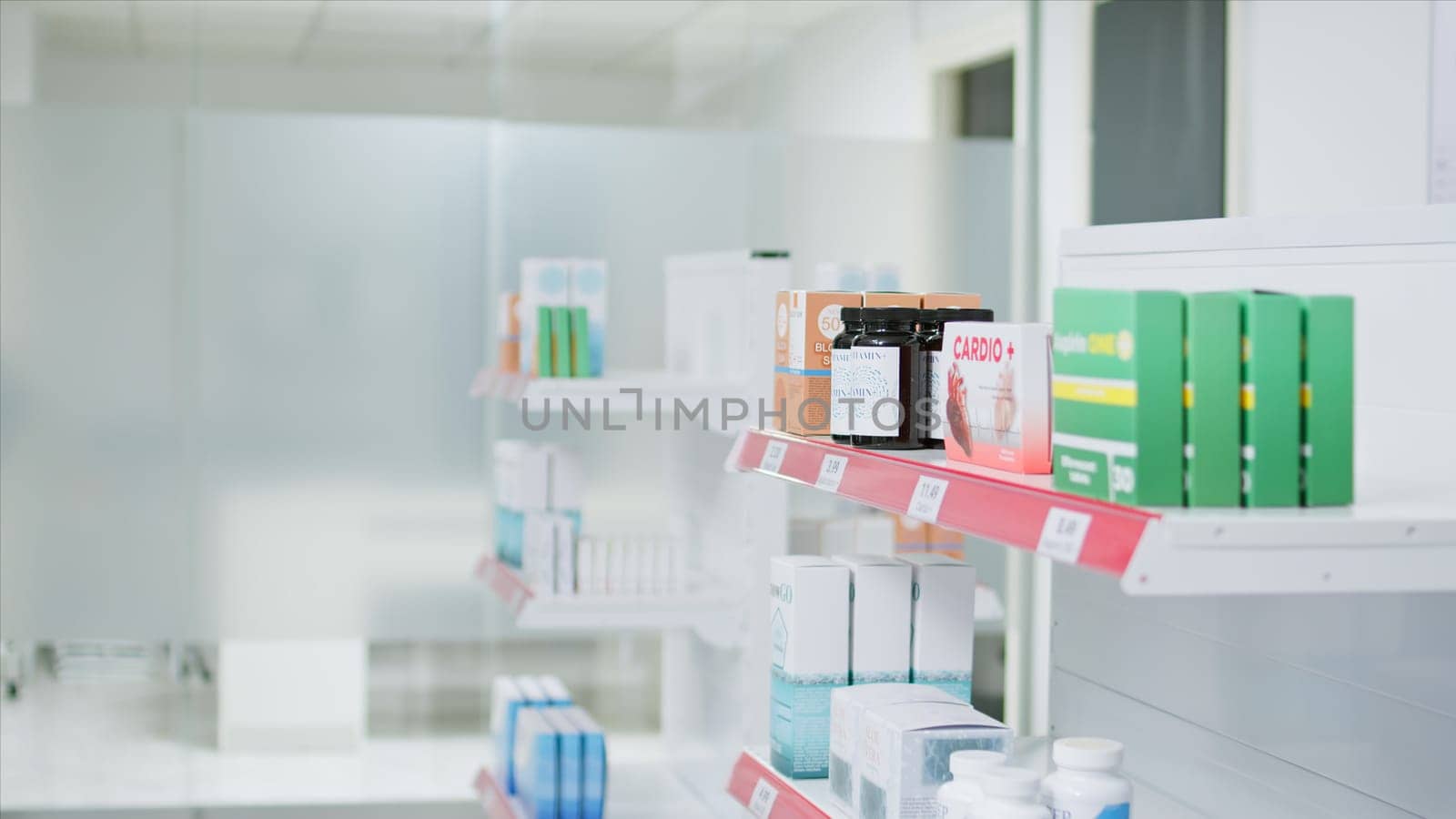 Selective focus of medicaments and supplements on shelves, empty pharmacy stacked with prescription medicine and medical supplies. Drugstore having antibiotics and pharmaceutics for sale.