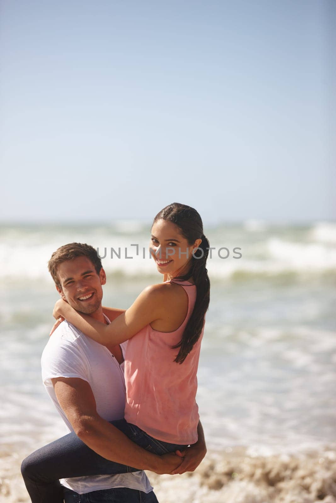 Ocean, couple and man lift woman, travel and freedom at beach for bonding and anniversary date in nature. Happy, partner and commitment with view, affection and playful outdoor for love and fun.