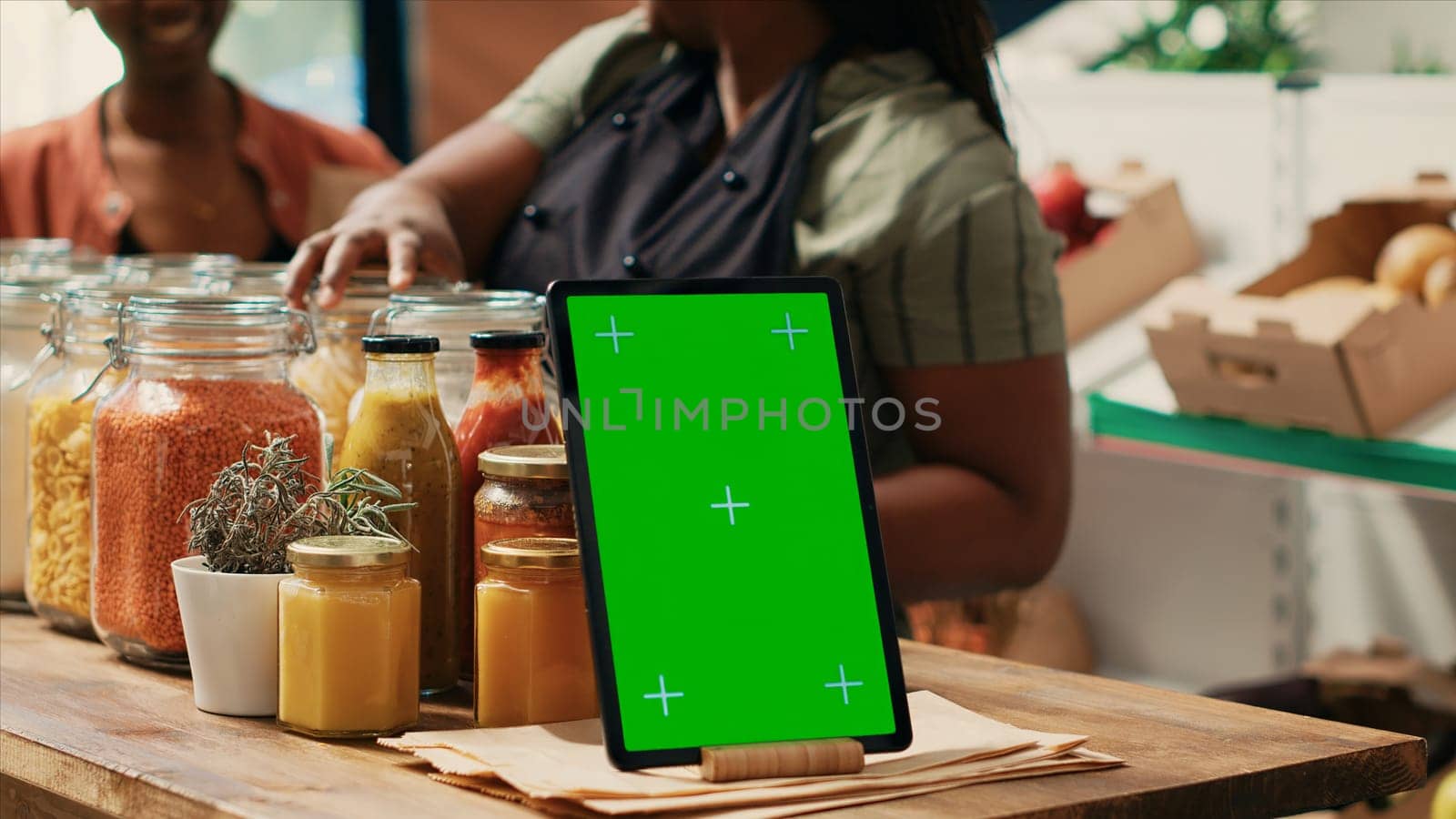Tablet with greenscreen display on farmers market counter by DCStudio