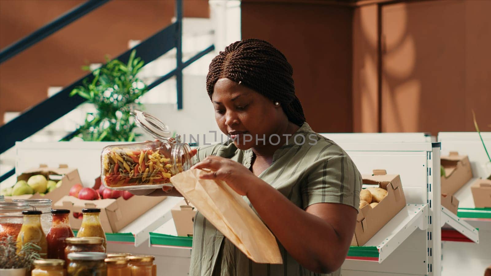 Customer pouring a type of pasta in ecological paper bag by DCStudio