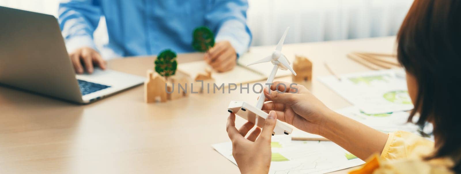 Businesswoman interested in investing in renewable energy at meeting table with environmental document scatter around. Business team discussion about green business project. Closeup. Delineation.