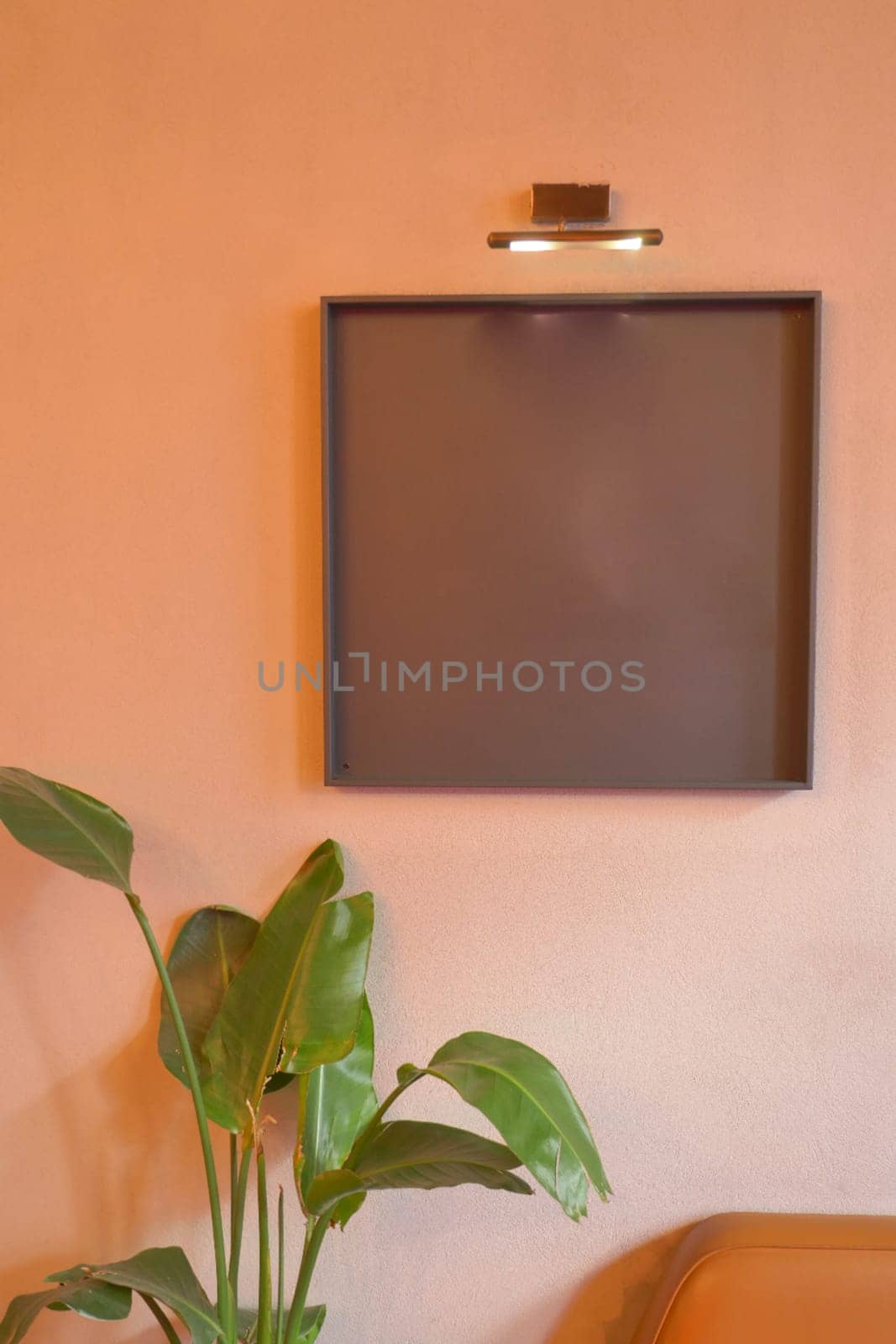 Black frame mockup in a living room .