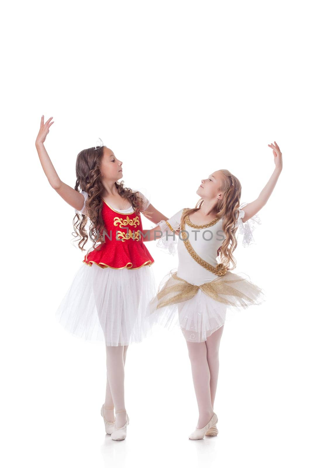 Beautiful young ballerinas dancing in pair, isolated on white