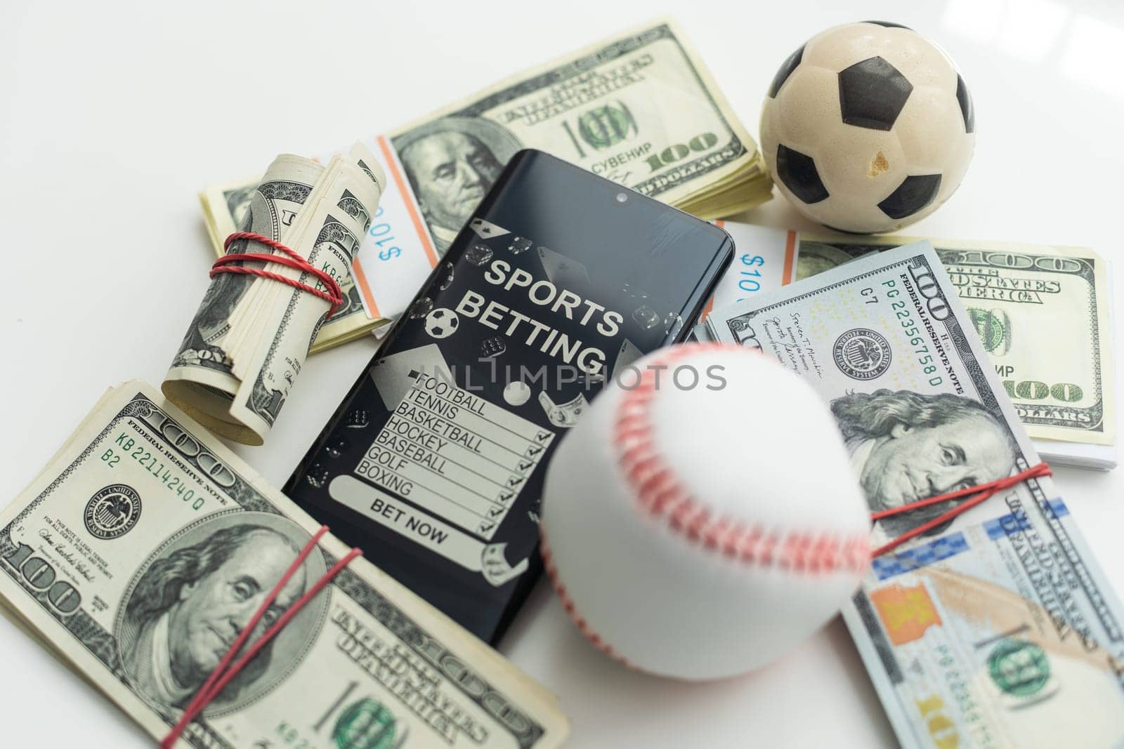 Smartphone with gambling mobile application and soccer ball with money close-up. Sport and betting concept. High quality photo