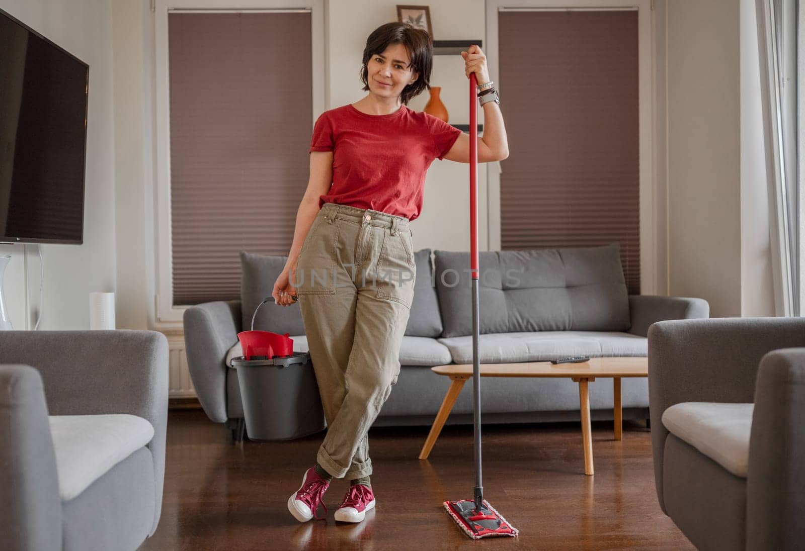 Cheerful Cleaner Stands In Room With Mop And Bucket, Washing Floor