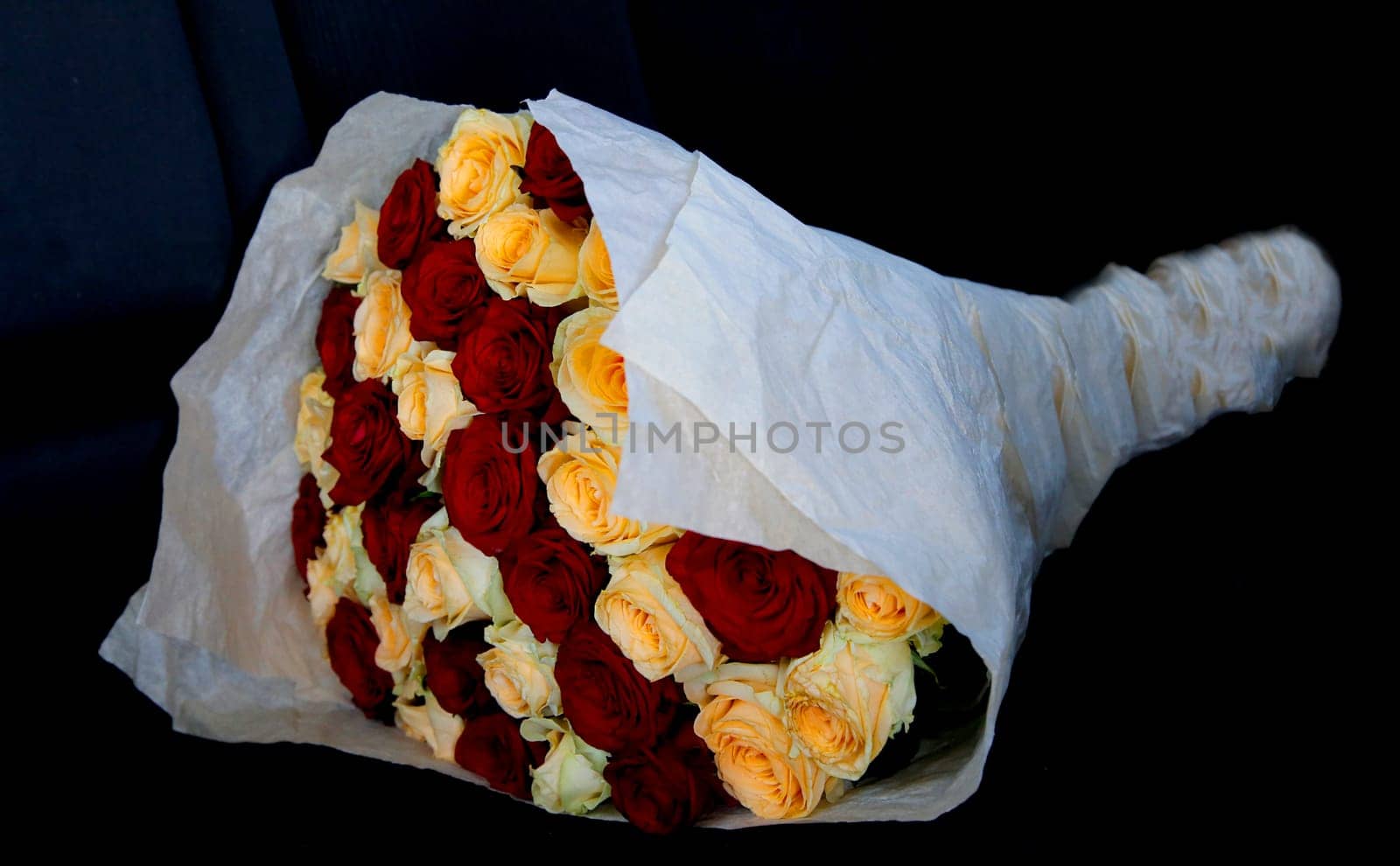 Bouquet of red and yellow roses on a black background close-up by Mastak80