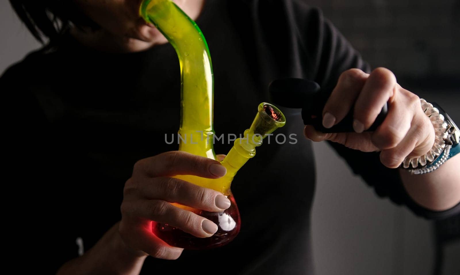Burning And Smoking Hemp Leaves From A Bong, Flame Close-Up, With Female Hands
